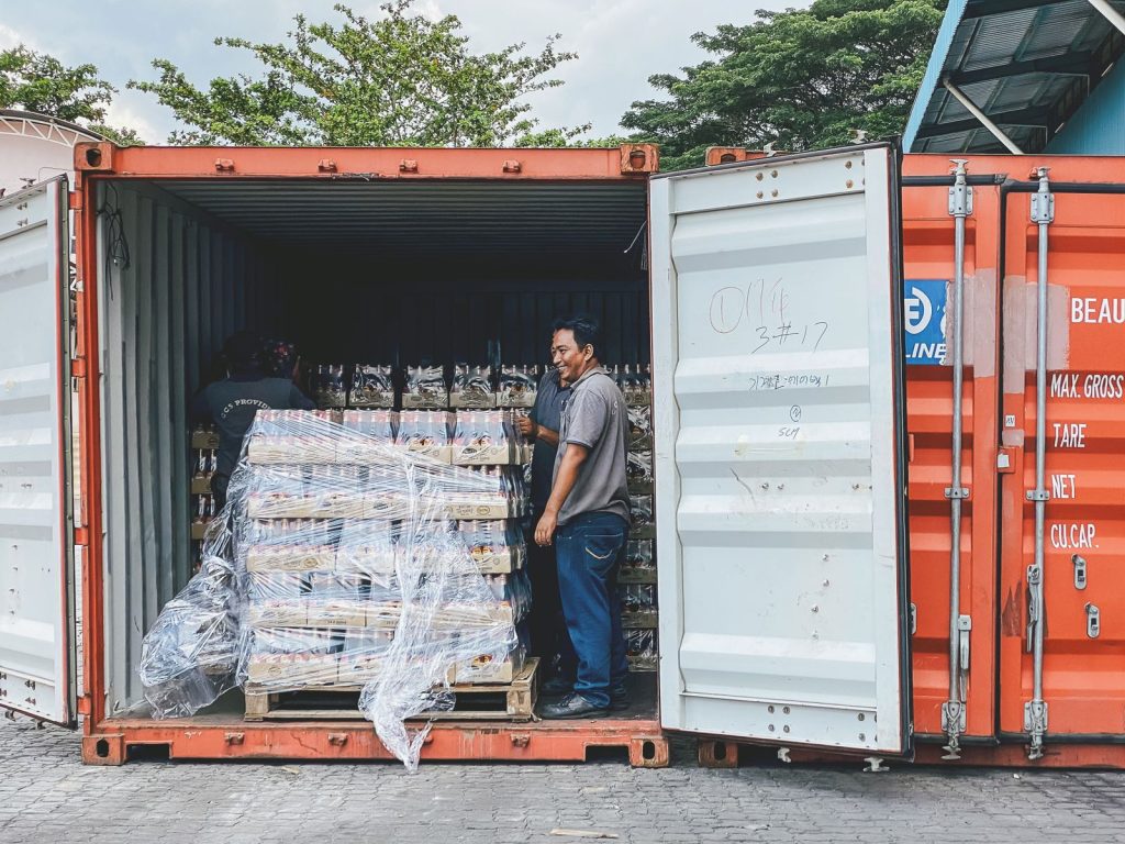 Workers loading cargo into a shipping container